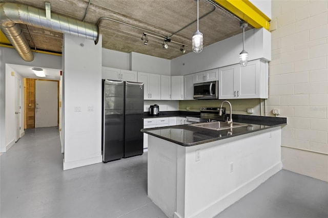 2515 SW 35th Pl Unit 203, Gainesville, FL 32608 - kitchen featuring stainless steel appliances, concrete floors, a peninsula, white cabinetry, and a high ceiling