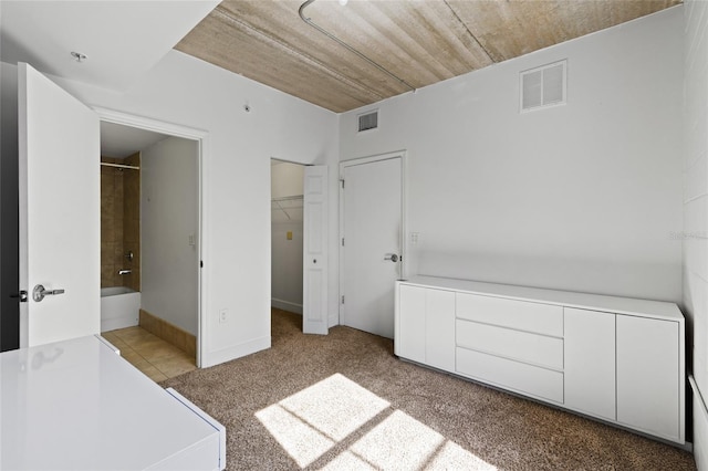 2515 SW 35th Pl Unit 203, Gainesville, FL 32608 - unfurnished bedroom featuring a spacious closet, ensuite bath, and carpet flooring