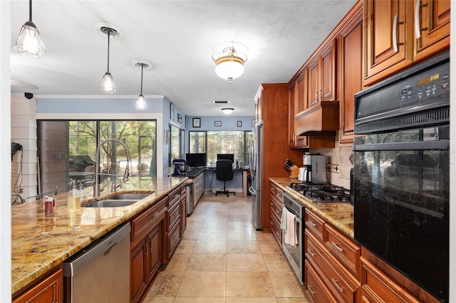 4714 NW 19th Pl, Gainesville, FL 32605 - kitchen featuring light stone counters, a sink, pendant lighting, and appliances with stainless steel finishes