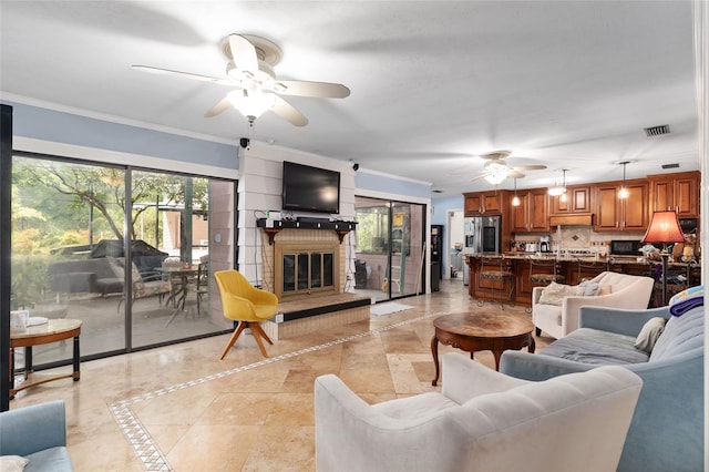 4714 NW 19th Pl, Gainesville, FL 32605 - living room with ceiling fan, visible vents, crown molding, light tile patterned floors, and a glass covered fireplace