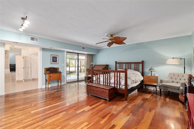 4714 NW 19th Pl, Gainesville, FL 32605 - bedroom featuring visible vents, crown molding, access to outside, and light wood-type flooring