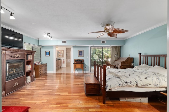 4714 NW 19th Pl, Gainesville, FL 32605 - bedroom featuring crown molding, rail lighting, visible vents, and light wood-type flooring