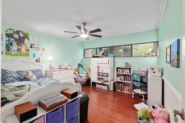 4714 NW 19th Pl, Gainesville, FL 32605 - bedroom with crown molding, a ceiling fan, and dark wood-style flooring