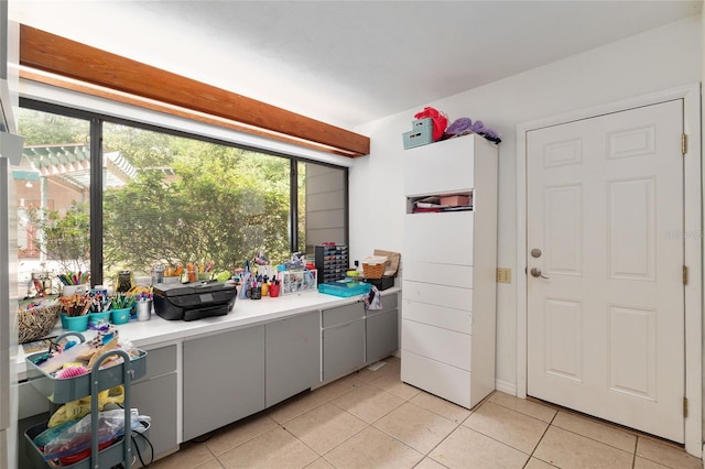 4714 NW 19th Pl, Gainesville, FL 32605 - laundry area featuring light tile patterned floors and a wealth of natural light