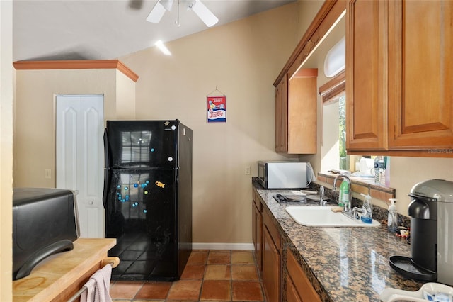 4714 NW 19th Pl, Gainesville, FL 32605 - kitchen featuring ceiling fan, brown cabinetry, a sink, baseboards, and freestanding refrigerator