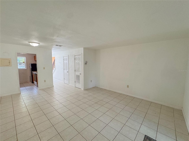 3935 SW 26th Ter Unit 3935A, Gainesville, FL 32608 - unfurnished room with light tile patterned flooring, baseboards, and visible vents