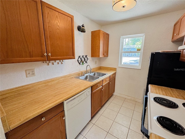 3935 SW 26th Ter Unit 3935A, Gainesville, FL 32608 - kitchen featuring brown cabinetry, a sink, white appliances, and light countertops