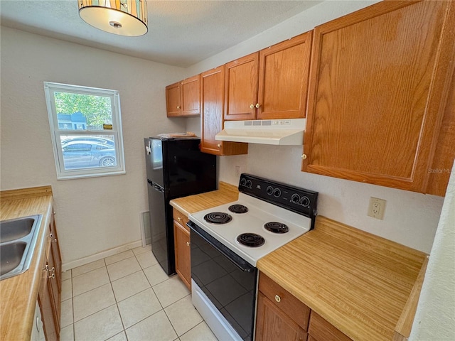 3935 SW 26th Ter Unit 3935A, Gainesville, FL 32608 - kitchen with light countertops, under cabinet range hood, brown cabinets, white electric stove, and light tile patterned floors