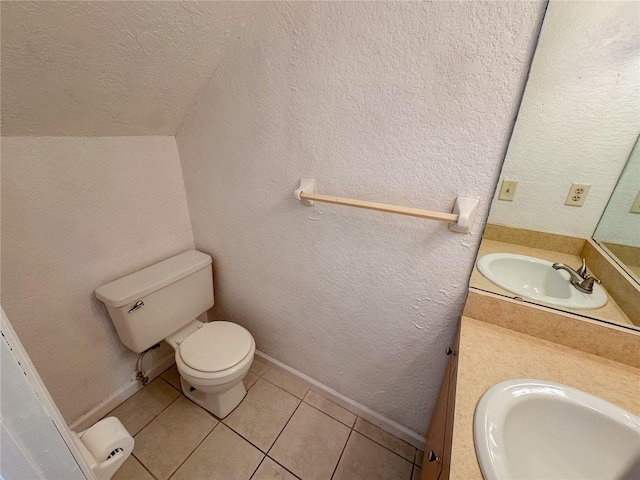3935 SW 26th Ter Unit 3935A, Gainesville, FL 32608 - bathroom with a textured wall, vanity, toilet, tile patterned floors, and a textured ceiling