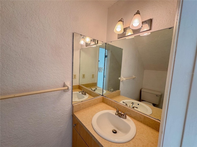 3935 SW 26th Ter Unit 3935A, Gainesville, FL 32608 - bathroom featuring vanity, a textured wall, and toilet