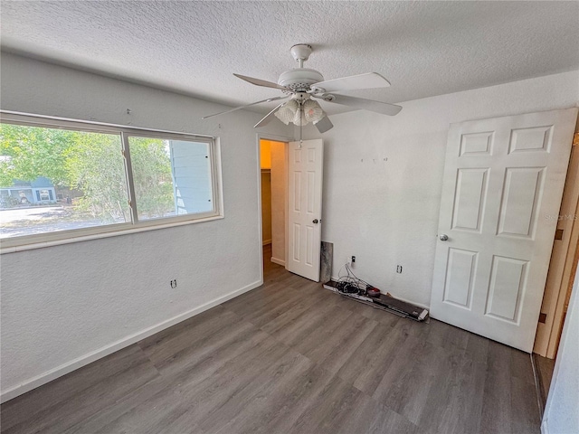 3935 SW 26th Ter Unit 3935A, Gainesville, FL 32608 - unfurnished bedroom featuring baseboards, a textured ceiling, ceiling fan, and wood finished floors