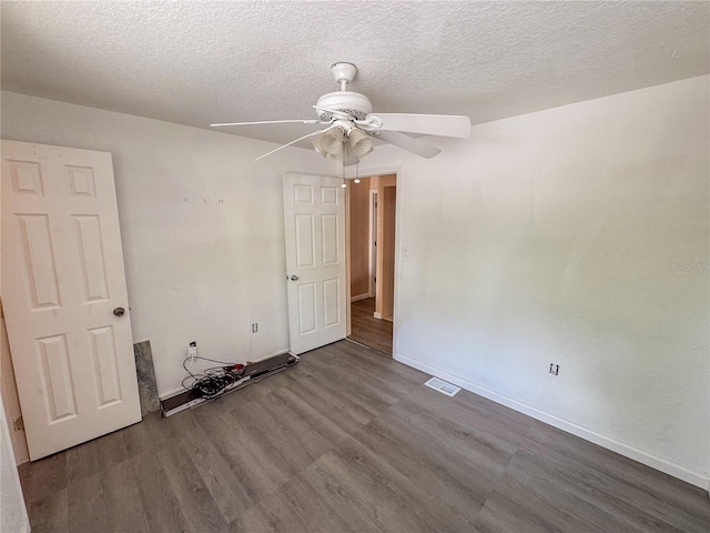 3935 SW 26th Ter Unit 3935A, Gainesville, FL 32608 - spare room with a ceiling fan, a textured ceiling, visible vents, wood finished floors, and baseboards