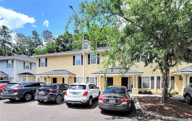 view of property featuring uncovered parking