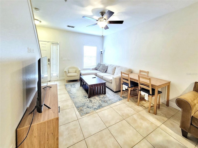 living room featuring ceiling fan, light tile patterned flooring, and baseboards