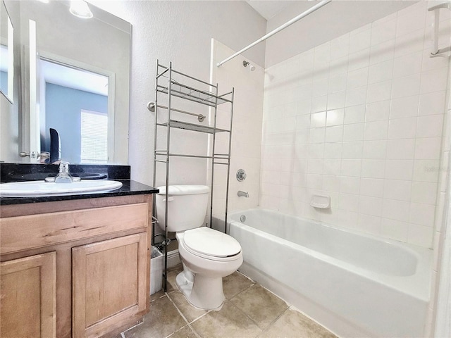 bathroom featuring tub / shower combination, toilet, vanity, and tile patterned flooring