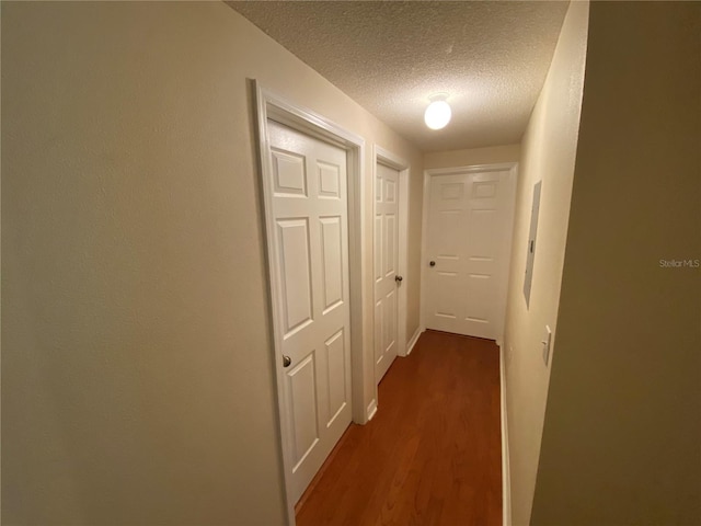 10000 SW 52nd Ave Unit 76, Gainesville, FL 32608 - hall with a textured ceiling and dark wood-style floors
