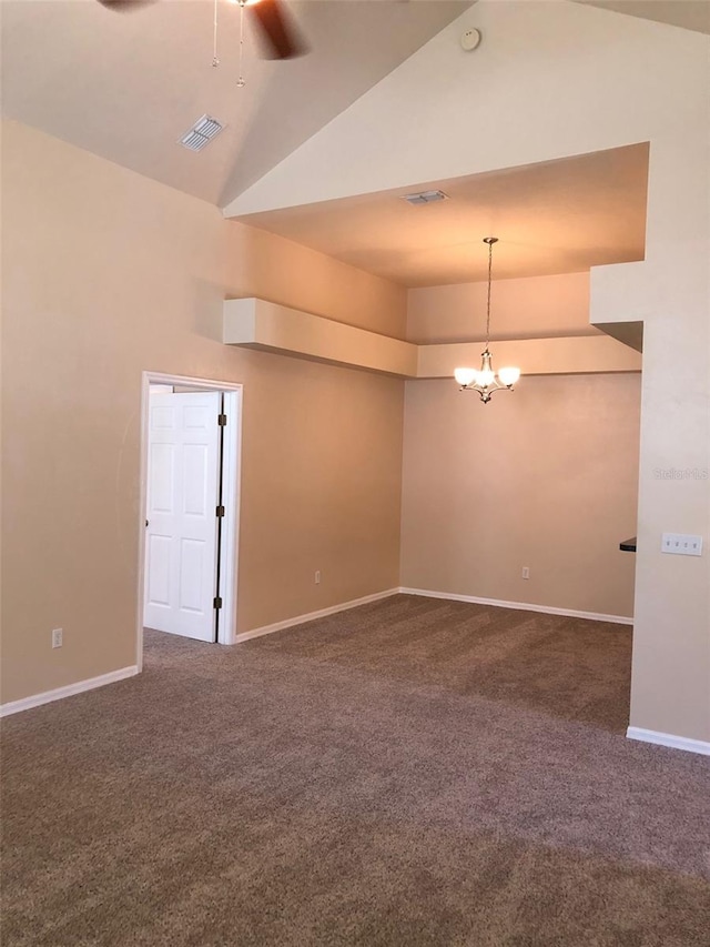 spare room featuring baseboards, visible vents, ceiling fan with notable chandelier, high vaulted ceiling, and dark carpet