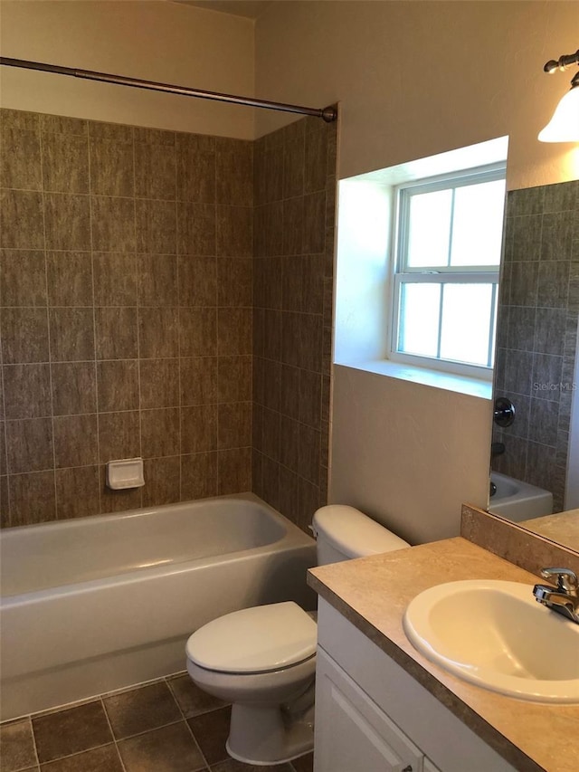 bathroom with tile patterned floors, toilet, vanity, and washtub / shower combination