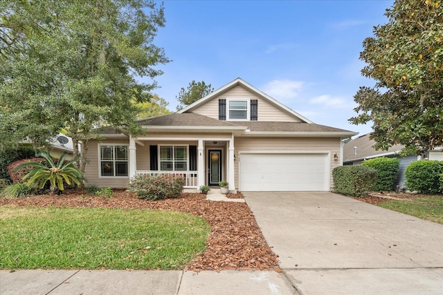 2184 NW 144th St, Newberry, FL 32669 - view of front of home featuring a front yard, an attached garage, concrete driveway, and covered porch