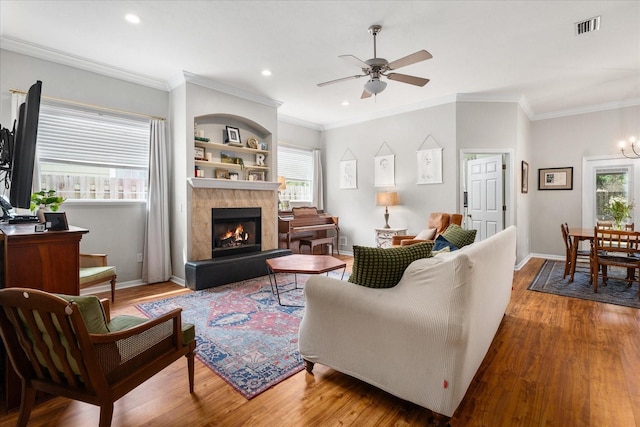 2184 NW 144th St, Newberry, FL 32669 - living room featuring a ceiling fan, wood finished floors, visible vents, and a healthy amount of sunlight