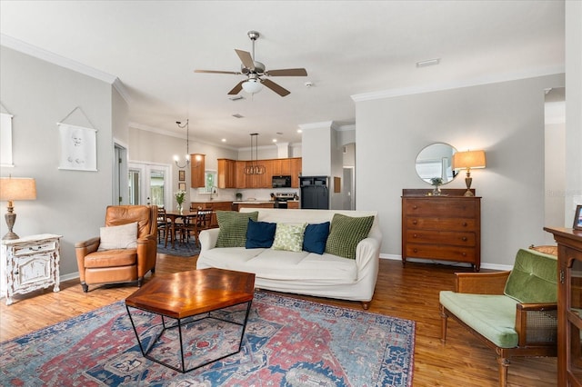 2184 NW 144th St, Newberry, FL 32669 - living room featuring ceiling fan, baseboards, crown molding, and wood finished floors