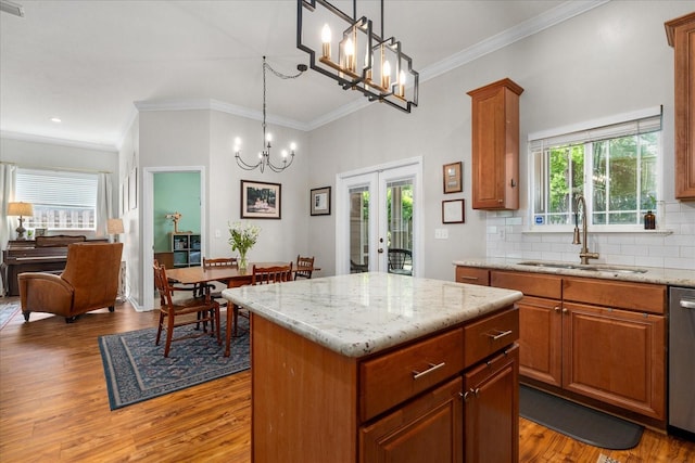 2184 NW 144th St, Newberry, FL 32669 - kitchen with light wood-style flooring, a notable chandelier, french doors, and a sink