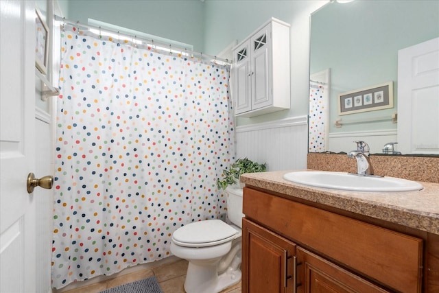 2184 NW 144th St, Newberry, FL 32669 - full bath featuring tile patterned floors, a wainscoted wall, toilet, vanity, and a shower with shower curtain