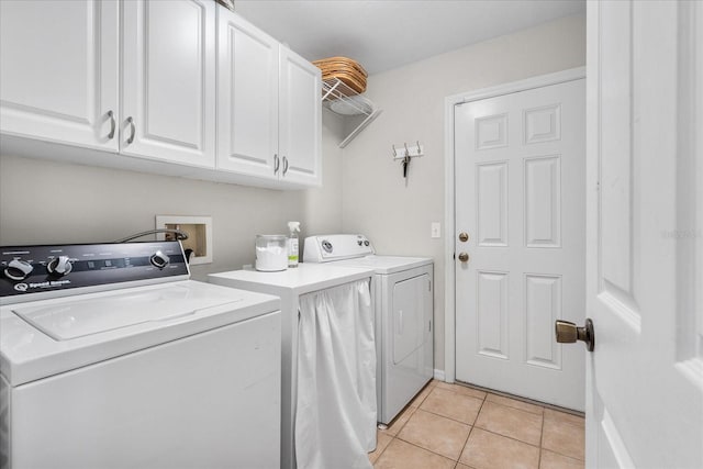 2184 NW 144th St, Newberry, FL 32669 - clothes washing area featuring washing machine and clothes dryer, cabinet space, and light tile patterned floors