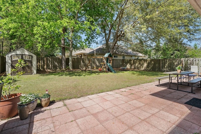 2184 NW 144th St, Newberry, FL 32669 - view of patio / terrace featuring a storage shed, an outbuilding, a fenced backyard, a playground, and outdoor dining area