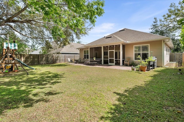 2184 NW 144th St, Newberry, FL 32669 - back of house with a fenced backyard, a sunroom, a patio area, and a yard