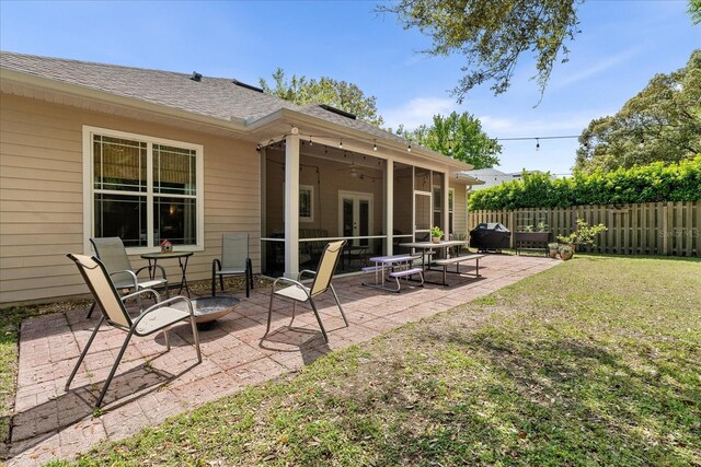 2184 NW 144th St, Newberry, FL 32669 - back of property featuring a lawn, a shingled roof, french doors, fence, and a patio