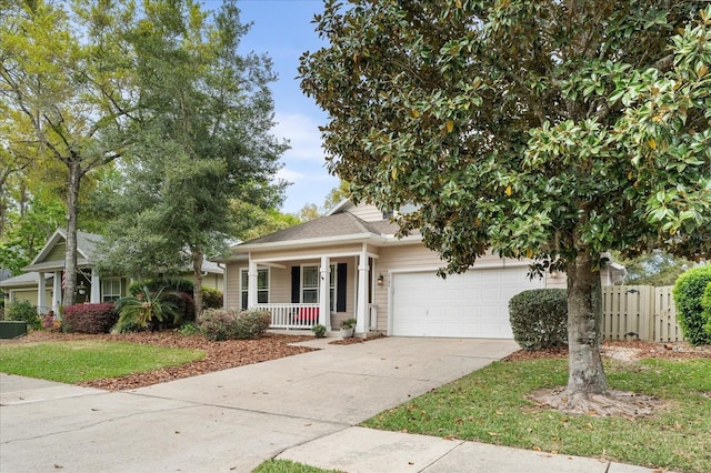 2184 NW 144th St, Newberry, FL 32669 - view of front facade featuring an attached garage, fence, covered porch, and concrete driveway