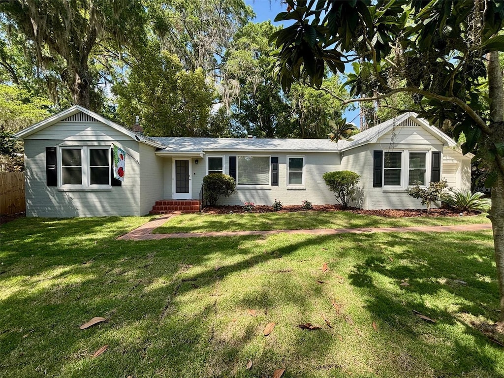 1404 NW 9th Ave, Gainesville, FL 32605 - ranch-style house featuring brick siding