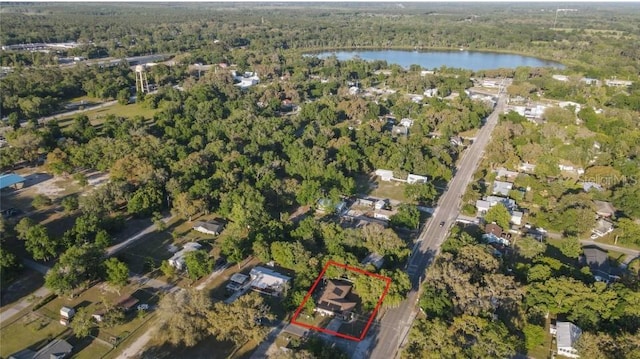 aerial view featuring a view of trees and a water view
