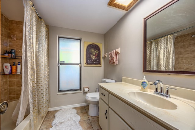 bathroom featuring tile patterned floors, toilet, vanity, baseboards, and shower / bath combo
