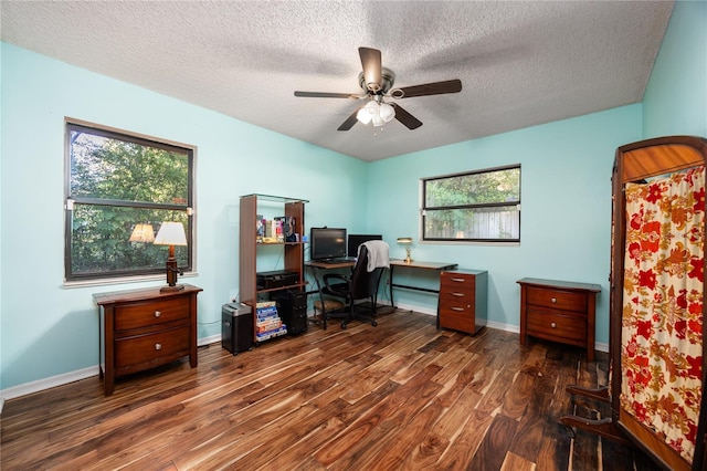 office space featuring baseboards, a ceiling fan, wood finished floors, and a textured ceiling