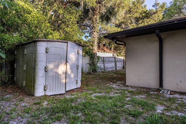 view of shed featuring fence