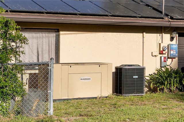details featuring stucco siding, fence, and cooling unit