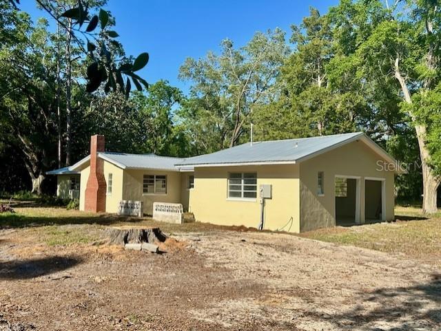 3530 NW County Road 236, Bell, FL 32619 - exterior space featuring a chimney and stucco siding