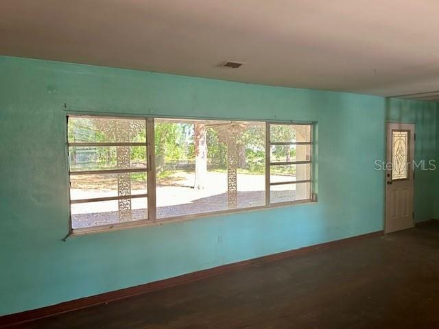 3530 NW County Road 236, Bell, FL 32619 - empty room featuring visible vents, a wealth of natural light, wood finished floors, and baseboards