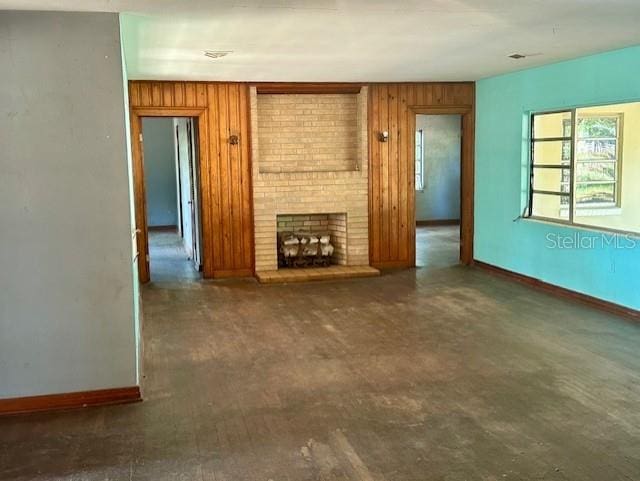 3530 NW County Road 236, Bell, FL 32619 - unfurnished living room featuring wood walls, a fireplace, and baseboards