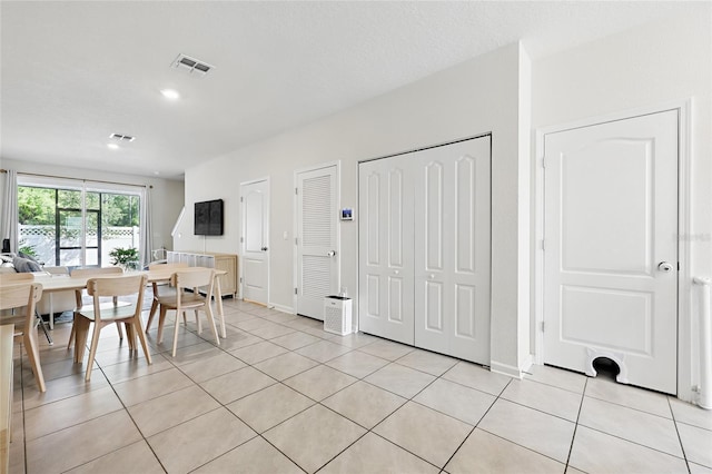 dining area featuring visible vents, baseboards, and light tile patterned floors