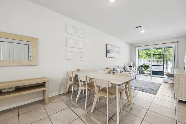 tiled dining room featuring visible vents and recessed lighting