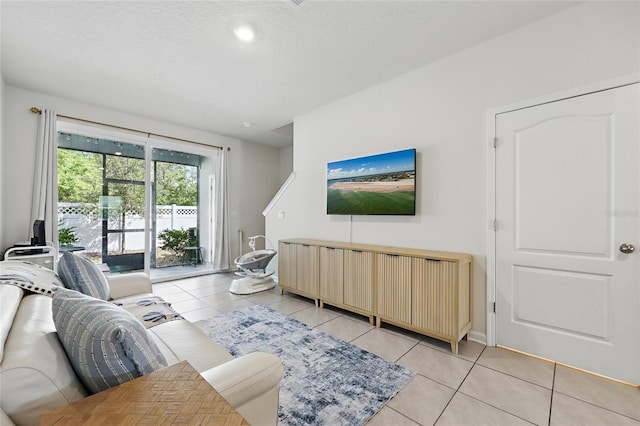 living area featuring light tile patterned floors and a textured ceiling