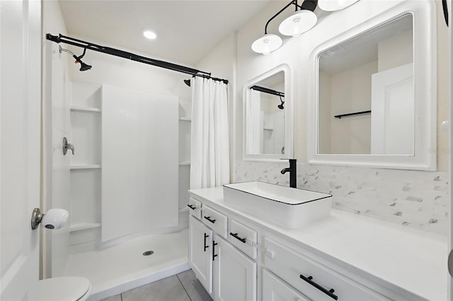 full bathroom featuring toilet, a stall shower, vanity, and tile patterned flooring