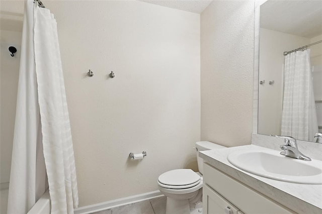 bathroom with toilet, tile patterned floors, vanity, and baseboards