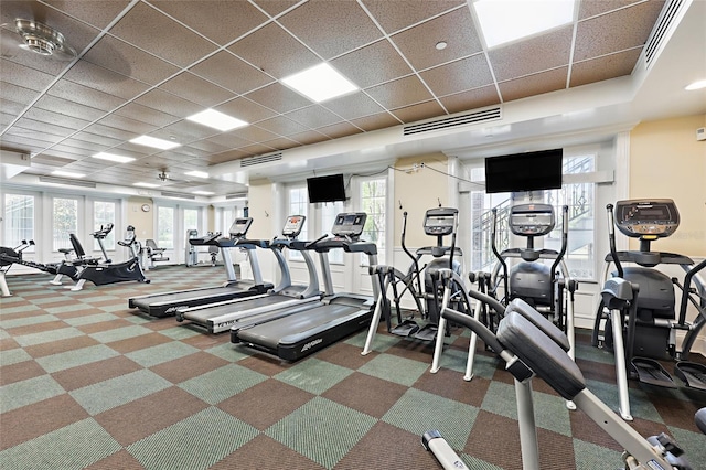 workout area featuring visible vents, a drop ceiling, and carpet floors