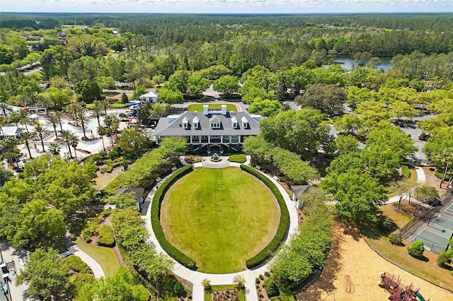 drone / aerial view featuring a wooded view and a water view