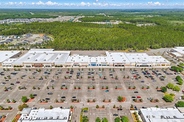 birds eye view of property with a view of trees