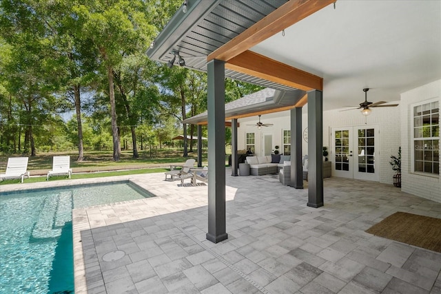 view of patio / terrace with french doors, an outdoor pool, ceiling fan, and an outdoor living space